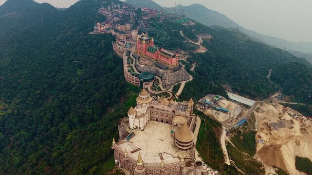 Stunning panorama aerial view of ba na hills lunar castles and French village at sunset in Da nang, Vietnam.