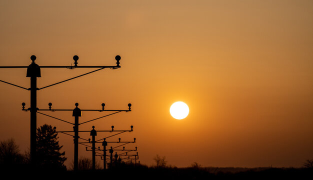 airport approach lighting system illuminating runway during sunset, bucharest, otp airport