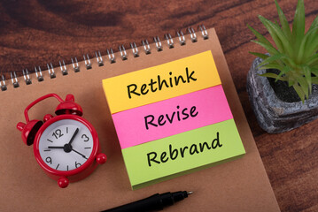 Rethink Revise Rebrand word on sticky colorful notes business concept