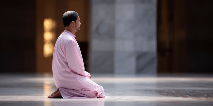 a muslim man is kneeling in the mosque, praying to god with soft lighting