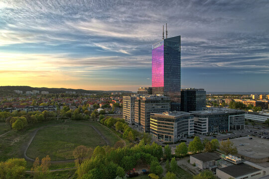 Aerial sunset view of the Olivia Star skyscraper and business centre overlooking green parkland and residential areas, Oliwa, Gdansk, Pomerania, Poland, Europe