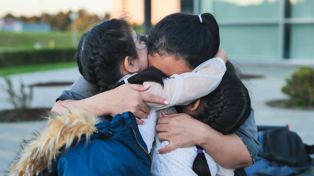 Family reunion, mother embracing children, feeling love and gratitude during homecoming