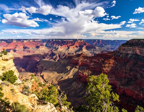 Grand Canyon panorama, vibrant colors, dramatic clouds