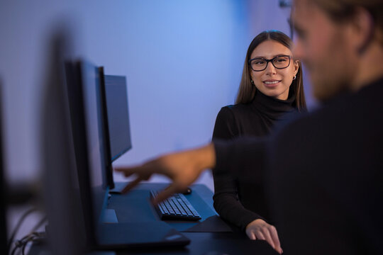 Young professional woman working in a collaborative tech environment