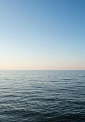 Fototapeta premium A vast expanse of smooth, undisturbed water meeting a seamless sky, creating an abstract and minimalist view of the natural world, ocean, space, open