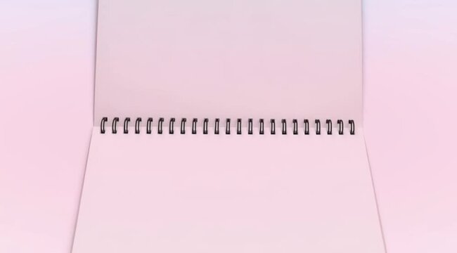 Close-up video of an open spiral notebook showing blank pages on a soft minimal background. Concept of writing, education, planning, creativity, note taking, and office or school supplies with copy sp
