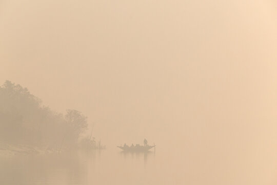 Fishing boat sailing at Sundarban tiger reserve in the foggy morning hours