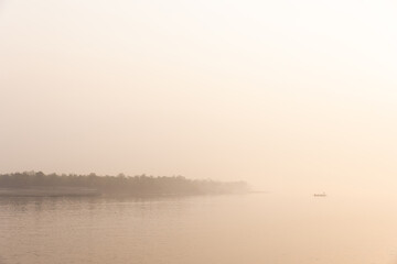 Fototapeta premium Fishing boat sailing in foggy morning at Sundarban tiger reserve in the mroning hours