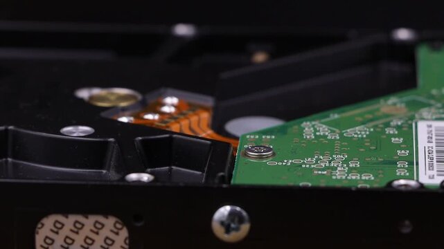 Close-up of an internal computer hard disk drive with circuit board detail.