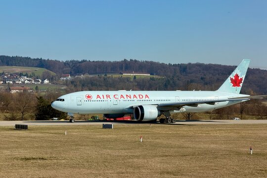 Zurich, Switzerland - February 25, 2026: Air Canada Boeing 777 taxiing on the taxiway toward the runway at Zurich Airport on a clear spring day.