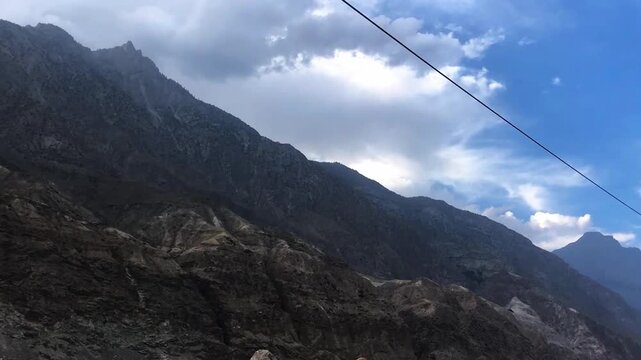 Dramatic close-up of Astore, Skardu, Pakistan mountains featuring dark rocky textures like black stone under clear sky. Stunning geological landscape and rugged terrain, perfect for nature, and travel