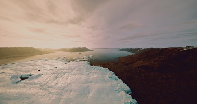 Ice melting landscape, Melting ice along rugged shoreline viewed from above, Aerial perspective of shrinking ice and thawed channels along harsh coastlines