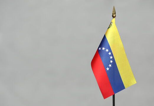 Table flag Venezuela on a blurred gray background