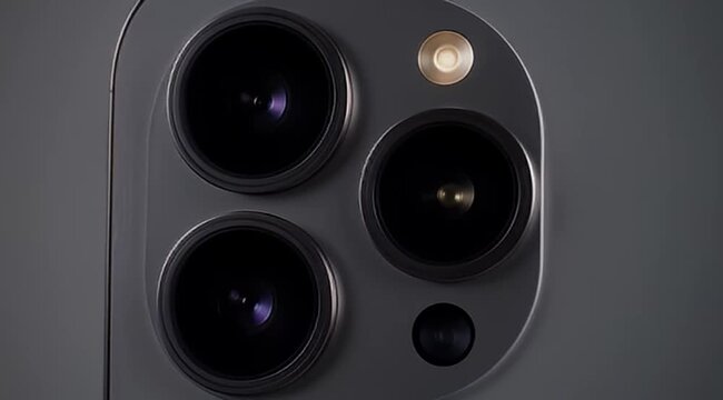 Macro shot of a cell phone showing the multiple camera lenses and flash