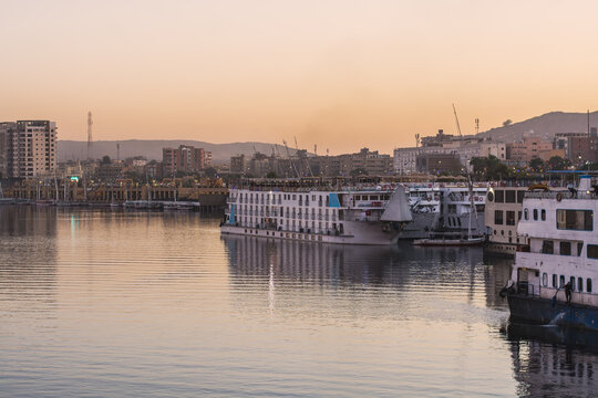 Ships in harbor on the nile at sunset, Aswan Egypt 