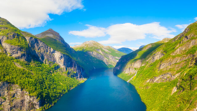 Seven Sisters Waterfall, Geiranger Fjord, Norway. Nature in fjords. Traveling through the Norwegian fjords. Scandinavia. View of nature from the drone. Vacation and travel in summer Norway