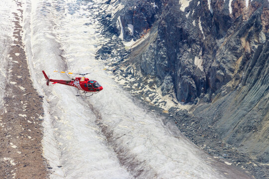 Helicopter flying over the snowy Swiss Alps in Switzerland