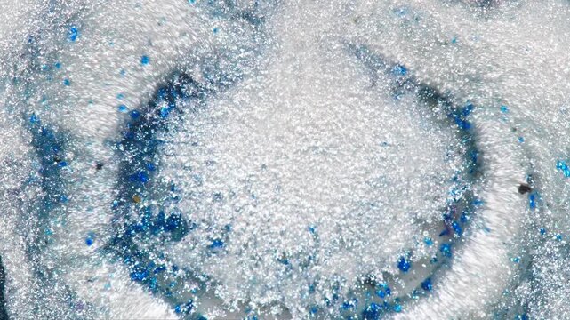 Silver Glitter Powder With Blue Sparkle Close-Up Texture and Shimmering Metallic Particles
