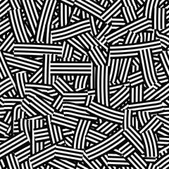 A seamless abstract pattern consisting of hand-drawn groups of black and white stripes, randomly intersecting and overlapping. Black and white abstract vector background for interior design, packaging