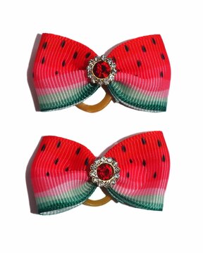 Two red and green rapeseed ribbon bows with a red stone in the middle for dogs on a white background. Dog accessories