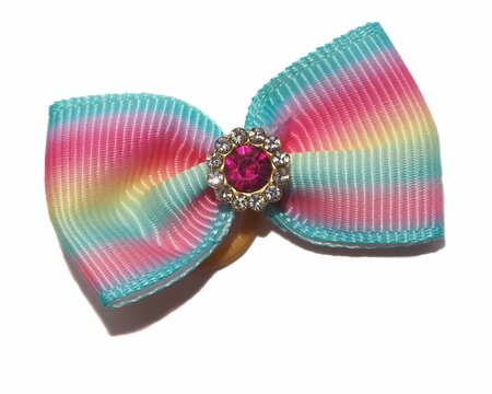 A bow for dogs made of blue and pink rapeseed ribbon with a shiny stone in the middle on a white background. Dog accessories