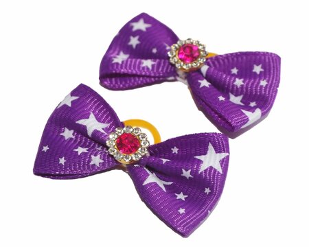 Two handmade purple fabric dog grooming bows with white stars and crystals on a white background. A fashionable accessory for small breed pets.