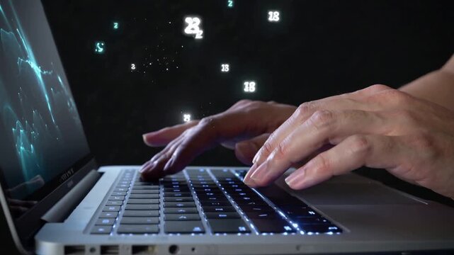 Close-up of hands typing on a laptop with digital data flow a person's actively on a keyboard, with glowing digital numbers and particles flowing around, suggesting processing or coding