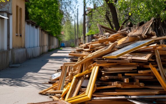 Pile of Broken Wooden Doors and Window Frames Stacked along Urban Street