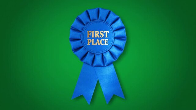 Blue first place ribbon rosette on green background in bright colorful lighting for award ceremony