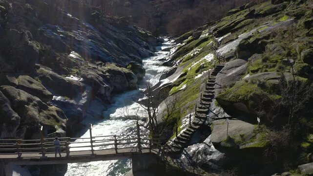Aerial view of Los Pilones Bridge area in Garganta de los Infiernos, Spain. Exceptional river flow surging through granite formations in Jerte Valley, creating powerful whitewater and dramatic flood.