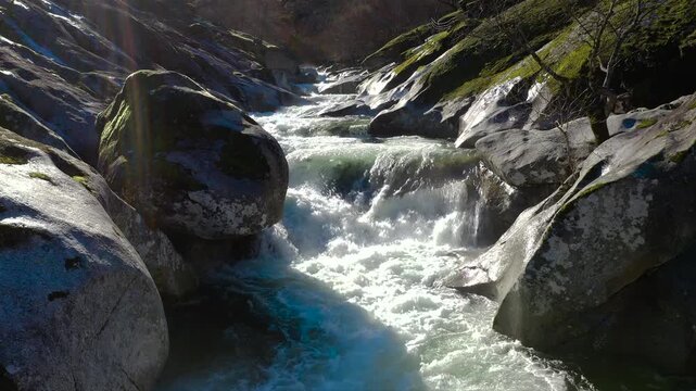 Aerial view of Los Pilones Bridge area in Garganta de los Infiernos, Spain. Exceptional river flow surging through granite formations in Jerte Valley, creating powerful whitewater and dramatic flood.