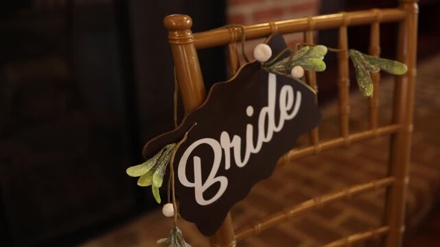 Bride sign on decorated wedding chair