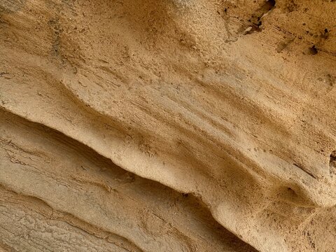 Layered coastal sandstone texture with natural erosion