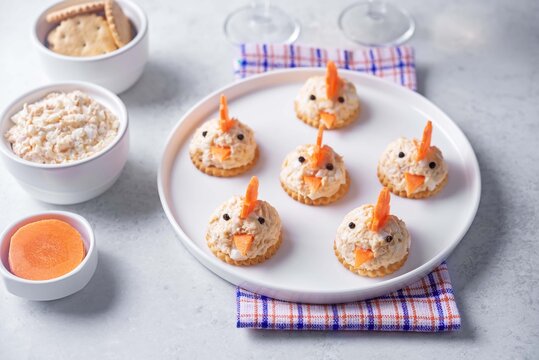 Salmon egg salad with crackers in the form of chicks in the plate for Easter holidays