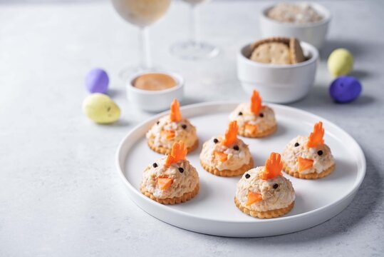Salmon egg salad with crackers in the form of chicks in the plate for Easter holidays
