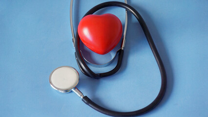 Stethoscope listening to a red heart model for health © enriscapes