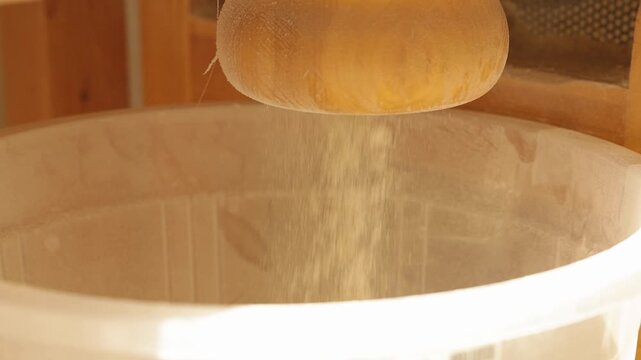 Sifting white flour through a traditional wooden sieve, bakery and home cooking concept.