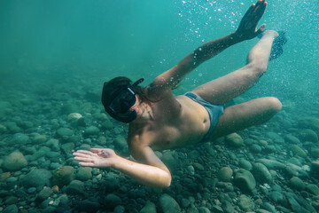 Man snorkeling and swimming underwater © Mulderphoto