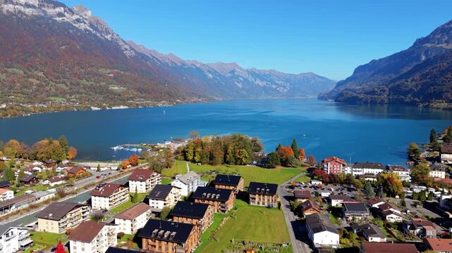 Lake Brienz autumn aerial landscape with turquoise water and forest. Interlaken, Canton of Bern, Switzerland.