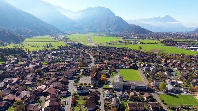 Interlaken Airport old site and Lake Brienz autumn street aerial view in Bonigen. Interlaken, Canton of Bern, Switzerland.