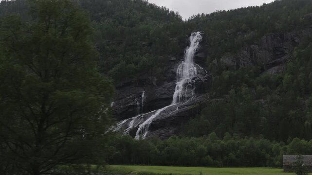 L&aring;tefossen waterfall in rainy evening in Norway