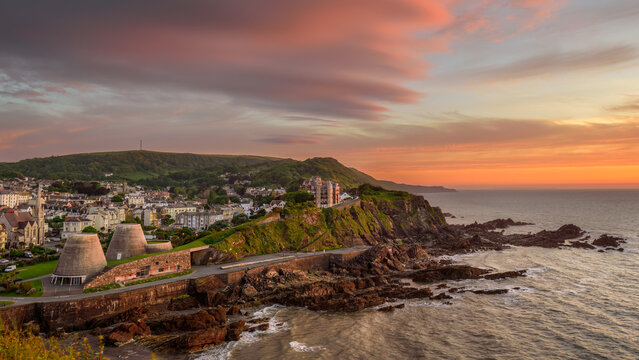A scenic view of the coastal town of Ilfracombe, North Devon, England from Capstone Hill at sunset.