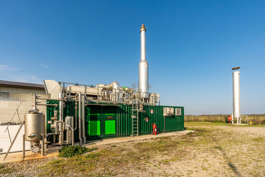 Agricultural biogas plant with cogeneration unit and anaerobic digester dome.