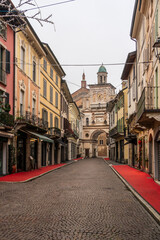 Fototapeta premium Via Mazzini and the Torrazzo arch in Crema with a festive red carpet.