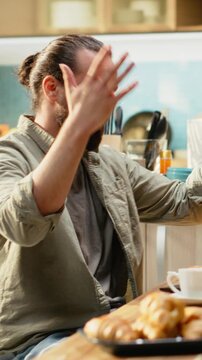 Vertical Video Overwhelmed desperate man receiving bad news during remote work, troubled and worried about difficult times and afraid of career failure. Stressful situation and anxiety at home