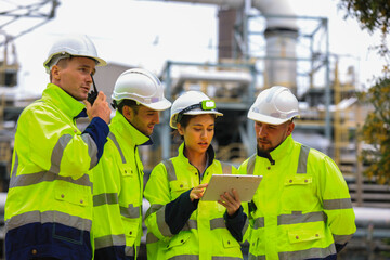 Industrial Engineer Using Digital Tablet for Predictive Maintenance in Oil and Gas Refinery. Team...