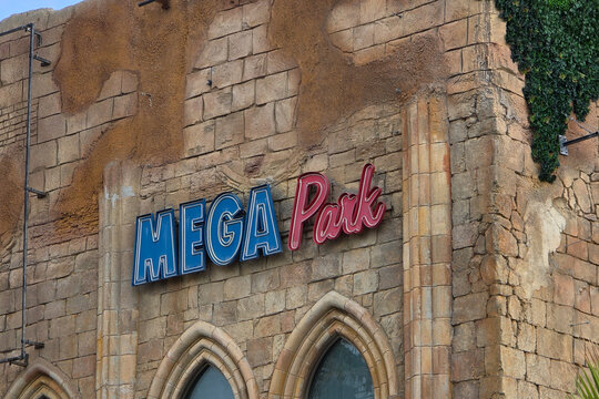 Exterior View of the Iconic Mega Park Sign on a Stone Wall in Platja de Palma, Mallorca, Spain - March 10, 2026