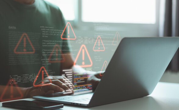 Software developer typing on laptop with virtual warning icons and source code interface, concept of cybersecurity risk, system error detection, debugging process, malware alert and secure programming