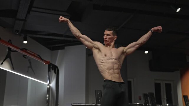 Muscular man with strong muscle. Strong guy with fit torso flexing muscle. Bodybuilding pose in gym. Bodybuilder strength. Strong sportsman bodybuilder. Strong and muscular sportsman. Six pack