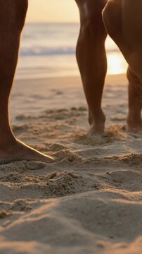 Group of friends dancing and toasting on the beach at sunset